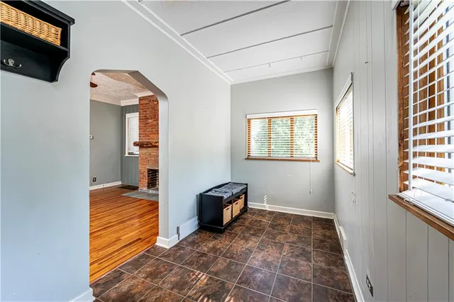 a view of hallway with wooden floor and windows