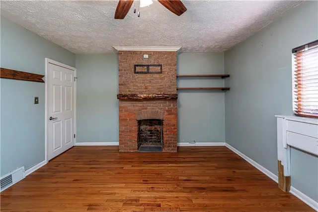 a view of a room with wooden floor and staircase