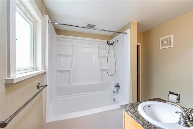 a bathroom with a sink toilet a mirror and shower