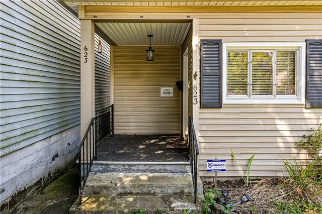 a view of a house with small yard and wooden fence