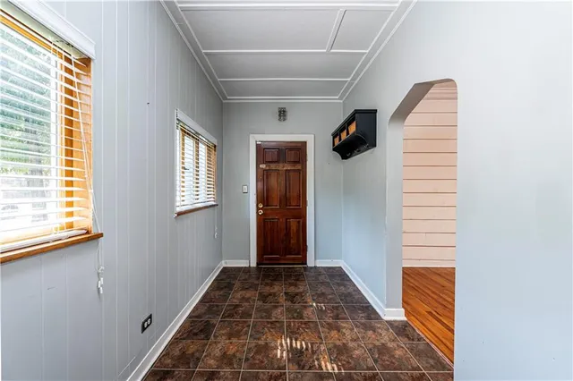 a view of a hallway to rooms and stairs