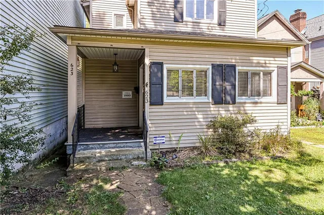 front view of a house with a yard