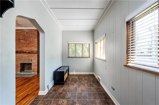 a view of a hallway with windows and a livingroom