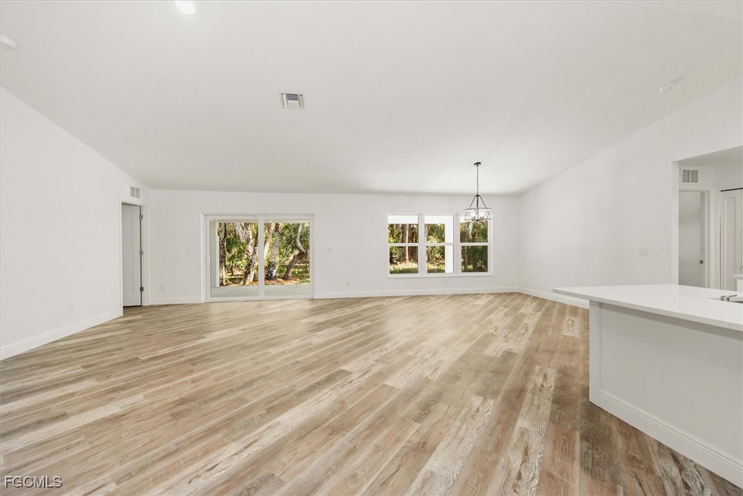 802 North Avenue Lehigh Acres, FL 33972 - Photo 12 of 39 an empty room with wooden floor and windows