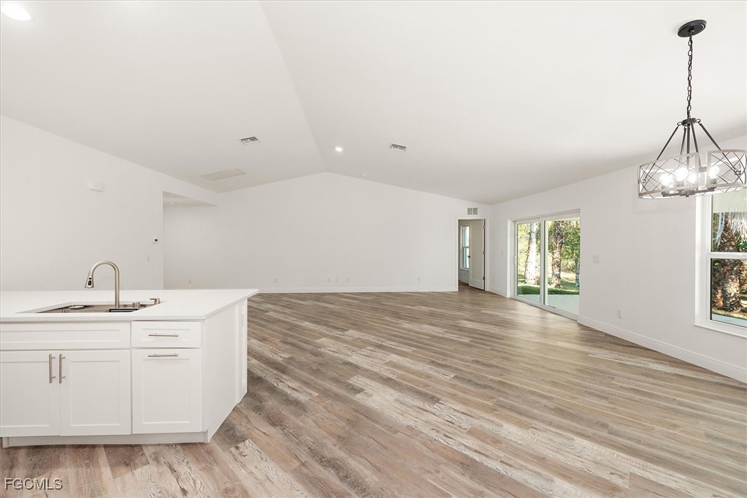802 North Avenue Lehigh Acres, FL 33972 - Photo 14 of 39 a view of empty room with window and wooden floor
