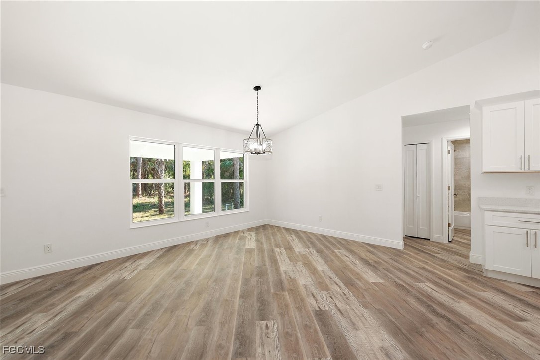 802 North Avenue Lehigh Acres, FL 33972 - Photo 18 of 39 a view of an empty room with wooden floor and a window