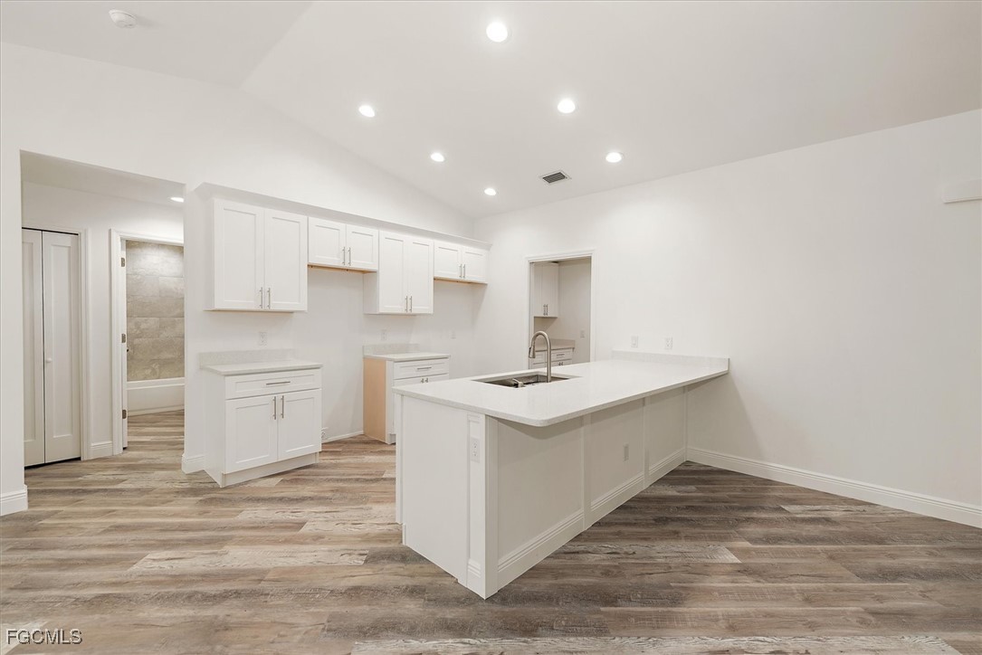 802 North Avenue Lehigh Acres, FL 33972 - Photo 8 of 39 a kitchen with a sink stove and refrigerator