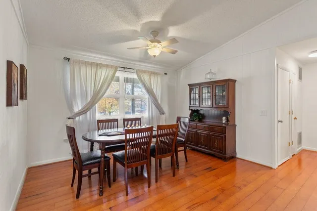 a view of a dining room with furniture window and wooden floor