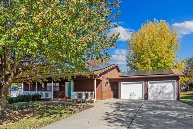 front view of a house with a tree