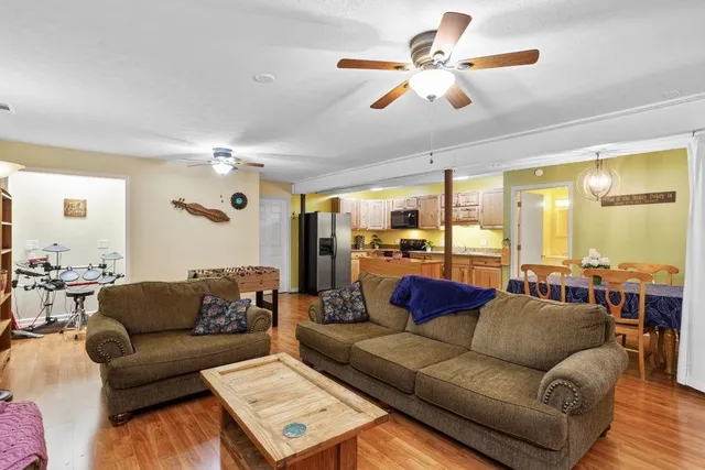 a living room with furniture and a chandelier