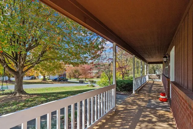 a view of a porch with wooden floor and fence