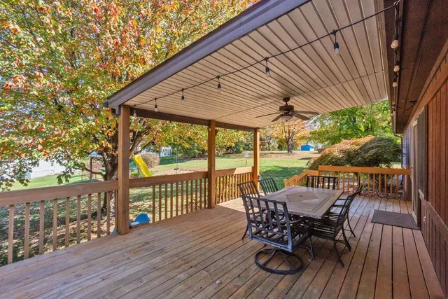 a view of a house with backyard and a tree