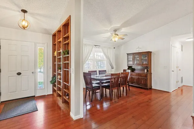 a view of a dining room with furniture and chandelier