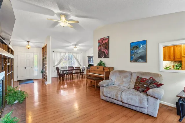 a living room with furniture and a chandelier