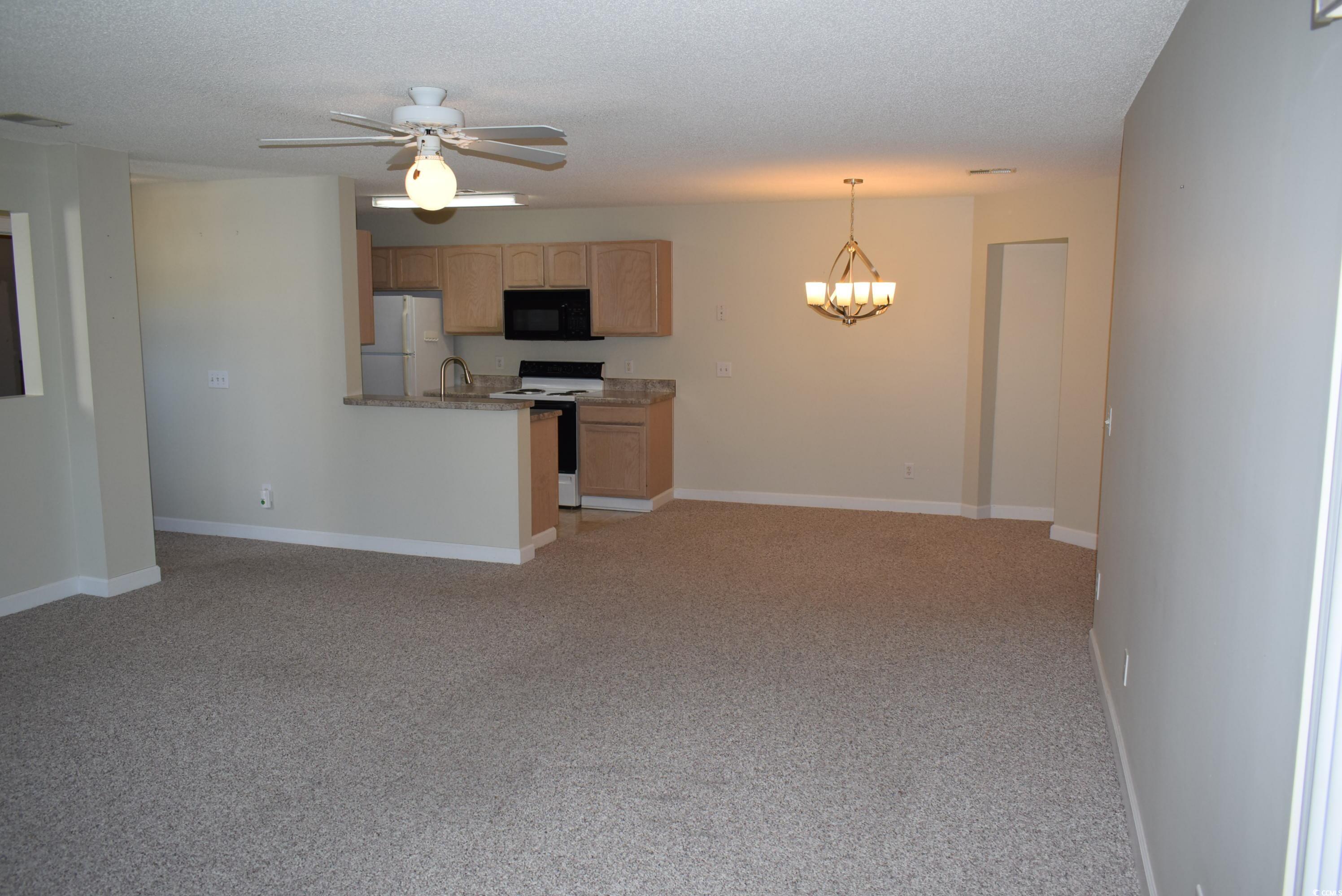 4300 Lotus Court, Unit G Murrells Inlet, SC 29576 - Photo 3 of 27 Interior space with light colored carpet, baseboards, and a textured ceiling