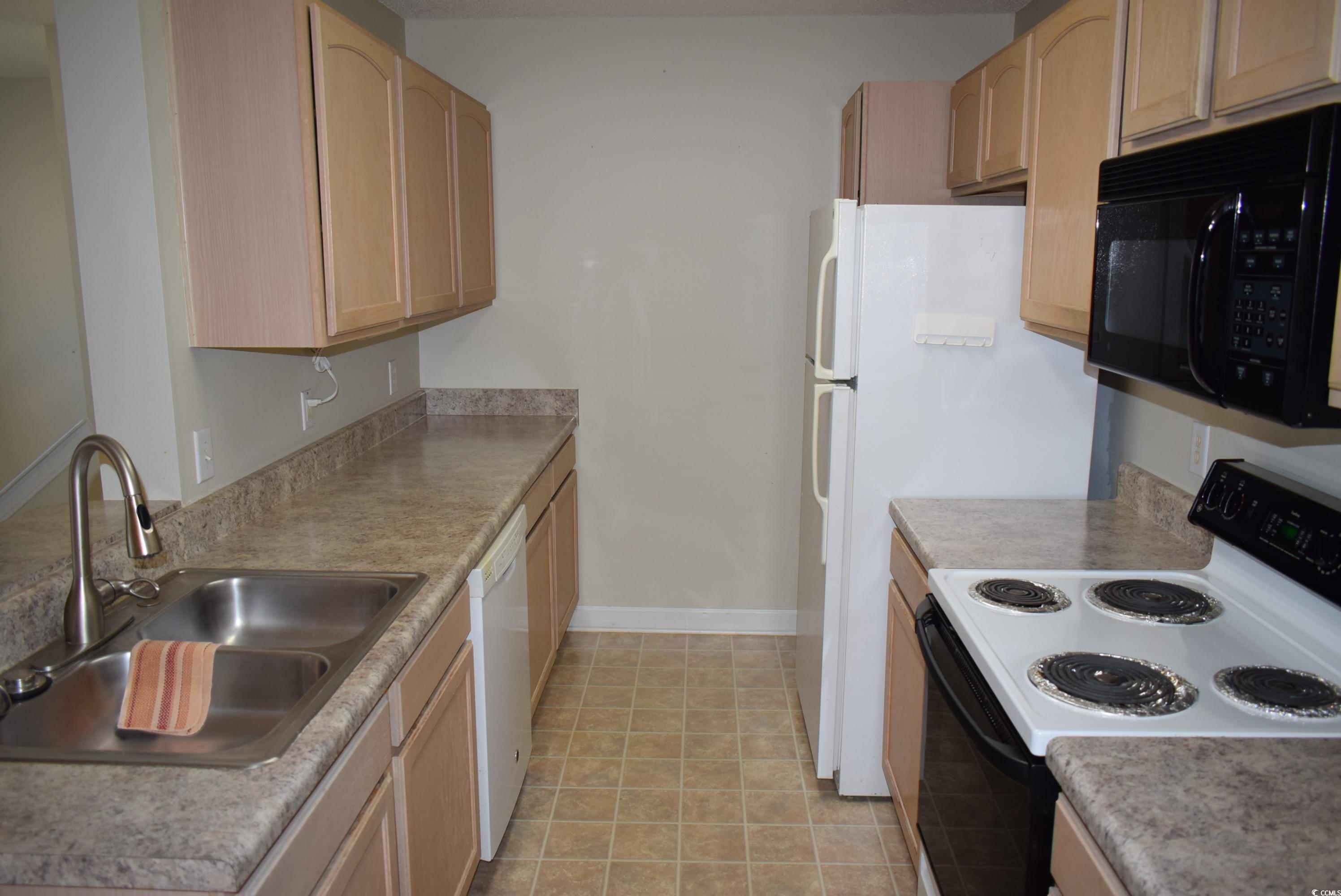 4300 Lotus Court, Unit G Murrells Inlet, SC 29576 - Photo 6 of 27 Kitchen featuring light brown cabinetry, a sink, range with electric stovetop, black microwave, and dishwasher