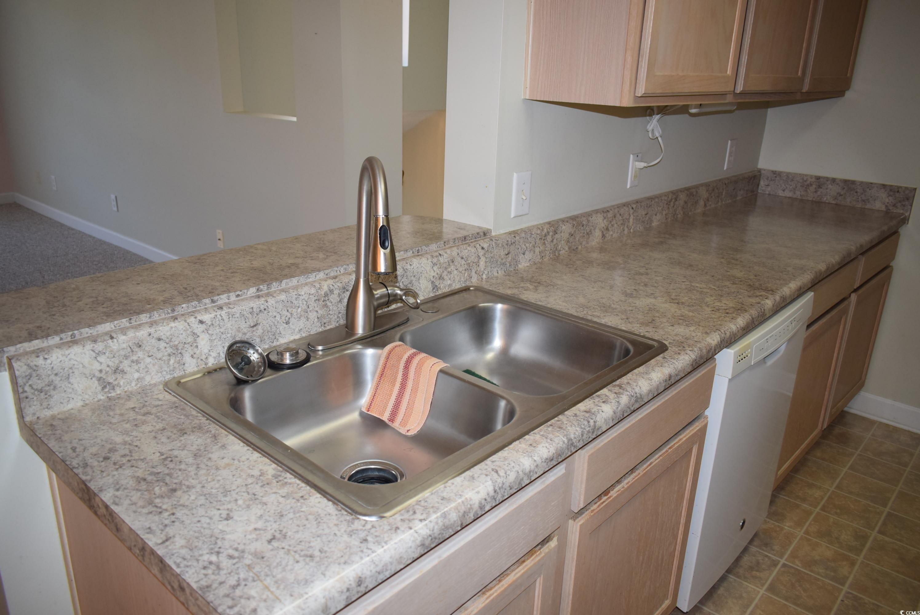 4300 Lotus Court, Unit G Murrells Inlet, SC 29576 - Photo 7 of 27 Kitchen with a sink, a peninsula, white dishwasher, light countertops, and baseboards