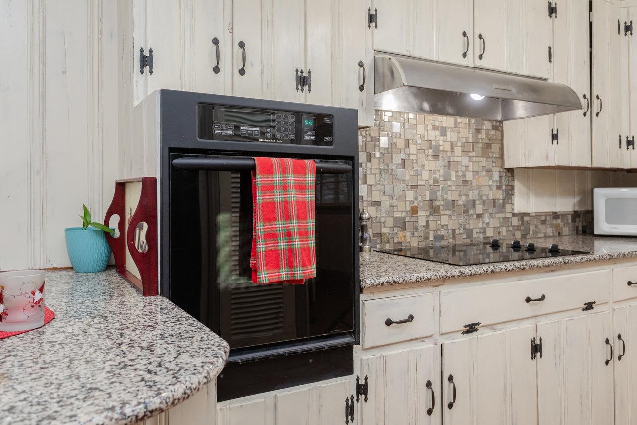 321 Franklin Street Harrisonburg, VA 22801 - Photo 17 of 54 a kitchen with stainless steel appliances kitchen island granite countertop a sink stove and cabinets