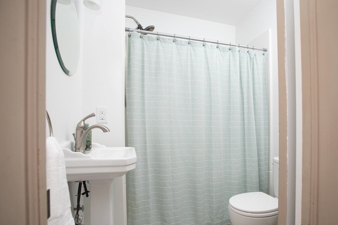 321 Franklin Street Harrisonburg, VA 22801 - Photo 19 of 54 a bathroom with a sink a toilet and shower curtain