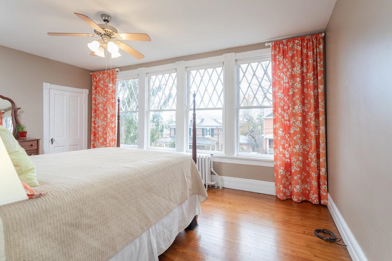 321 Franklin Street Harrisonburg, VA 22801 - Photo 29 of 54 a bedroom with a large bed and a chandelier