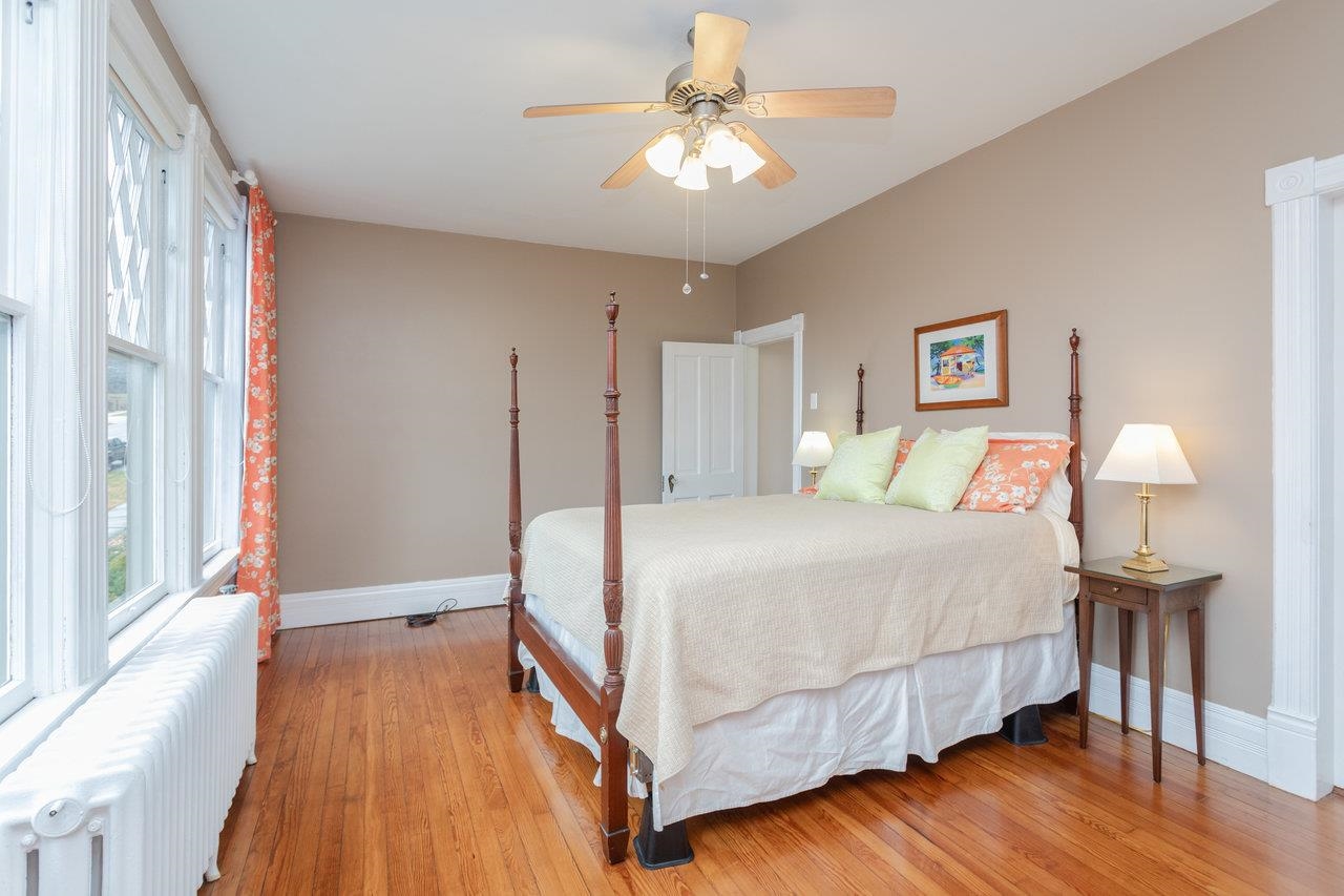321 Franklin Street Harrisonburg, VA 22801 - Photo 30 of 54 a bedroom with a bed and a chandelier