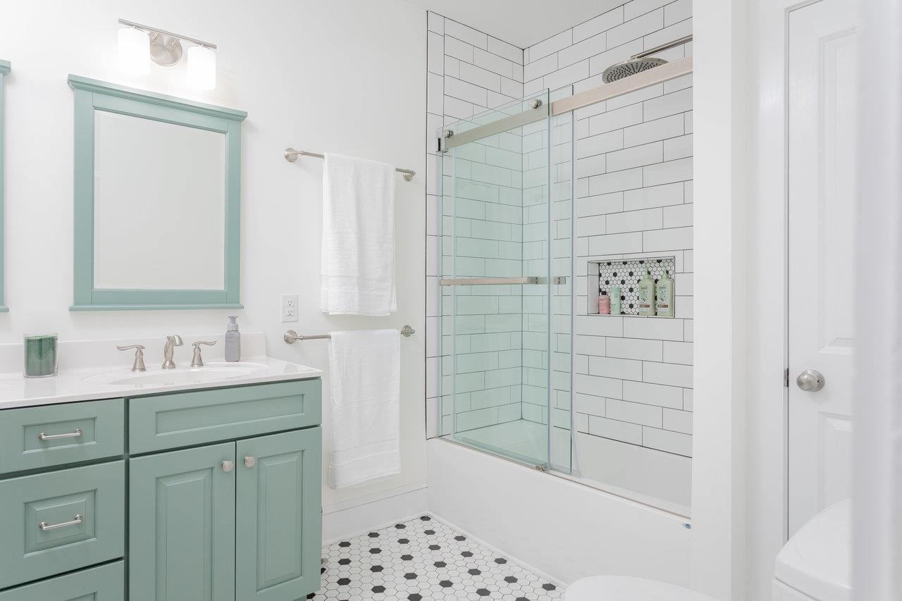 321 Franklin Street Harrisonburg, VA 22801 - Photo 31 of 54 a bathroom with a shower sink and mirror