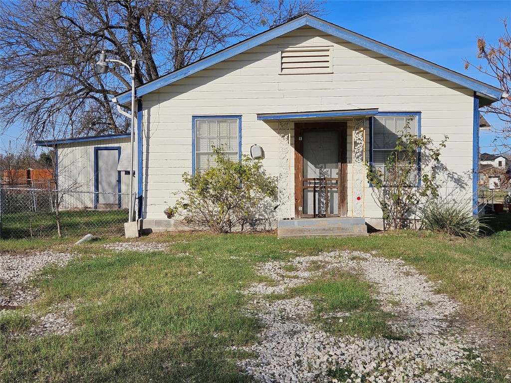 501 Burnet Street Manor, TX 78653 - Photo 14 of 22 a front view of a house with garden