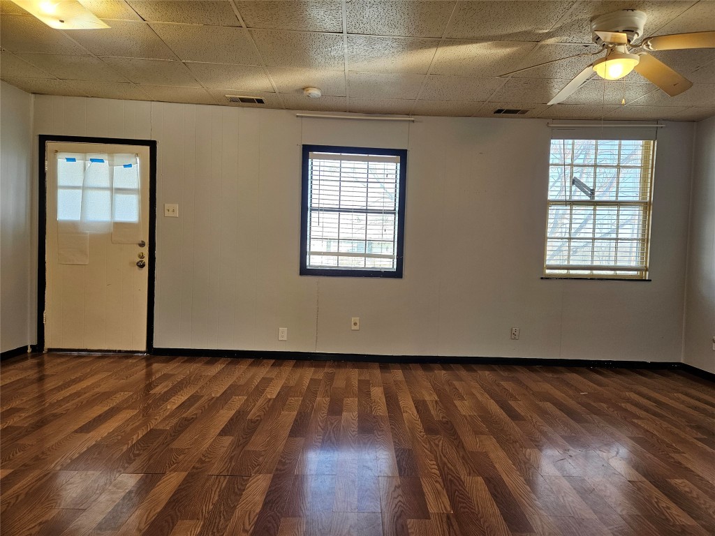 501 Burnet Street Manor, TX 78653 - Photo 16 of 22 an empty room with wooden floor and windows