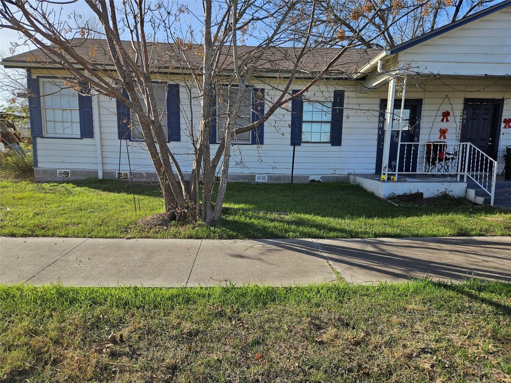 501 Burnet Street Manor, TX 78653 - Photo 2 of 22 a front view of a house with garden