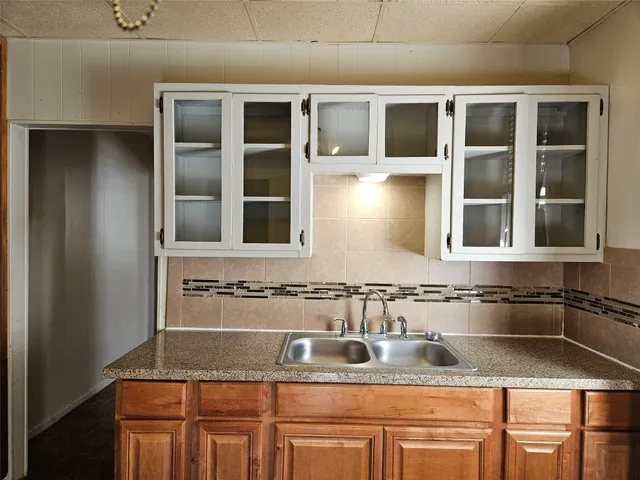 a bathroom with a granite countertop sink and mirror