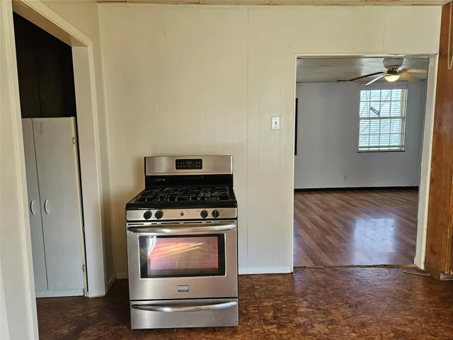 a stove top oven sitting inside of a kitchen