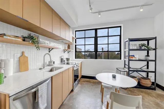 a kitchen with a sink cabinets and window