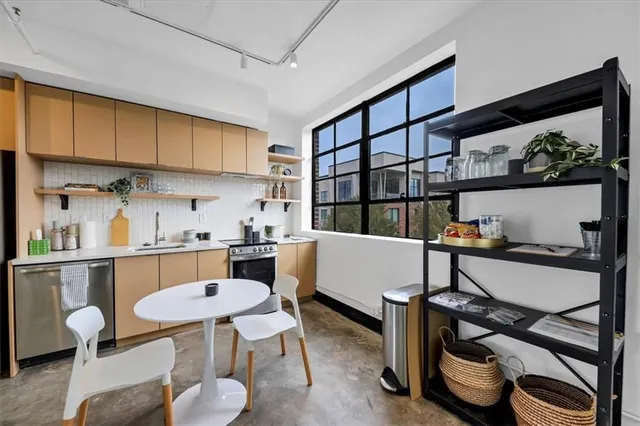 a living room with furniture a rug and a table