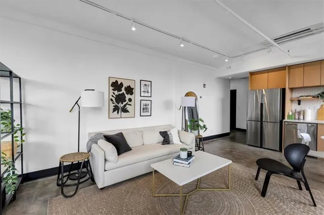 a living room with furniture a rug and a table