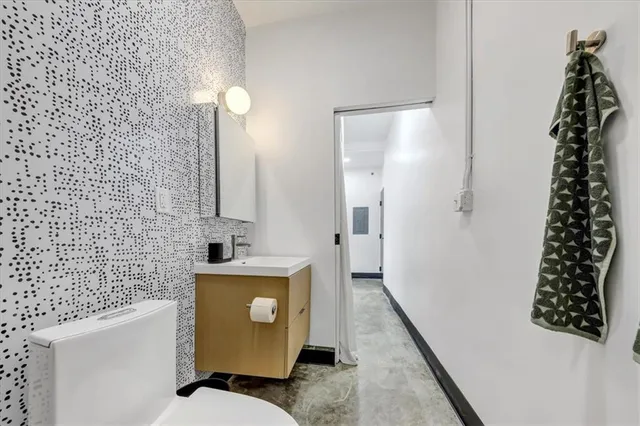 a bathroom with a sink toilet and shower