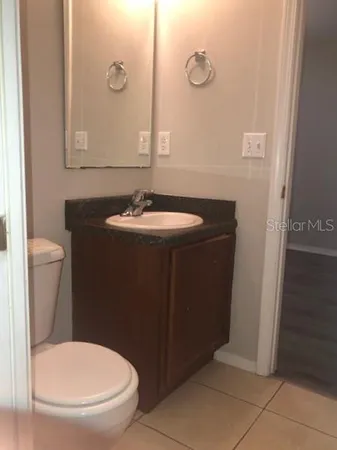 a bathroom with a sink toilet and mirror
