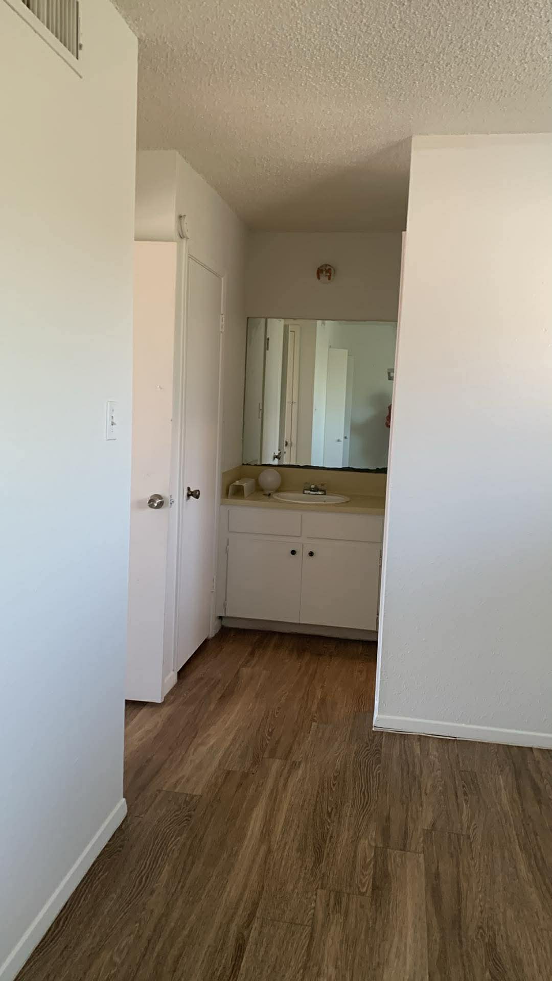 2627 Jones Road Austin, TX 78745 - Photo 8 of 8 Hallway featuring dark wood-style flooring and a textured ceiling
