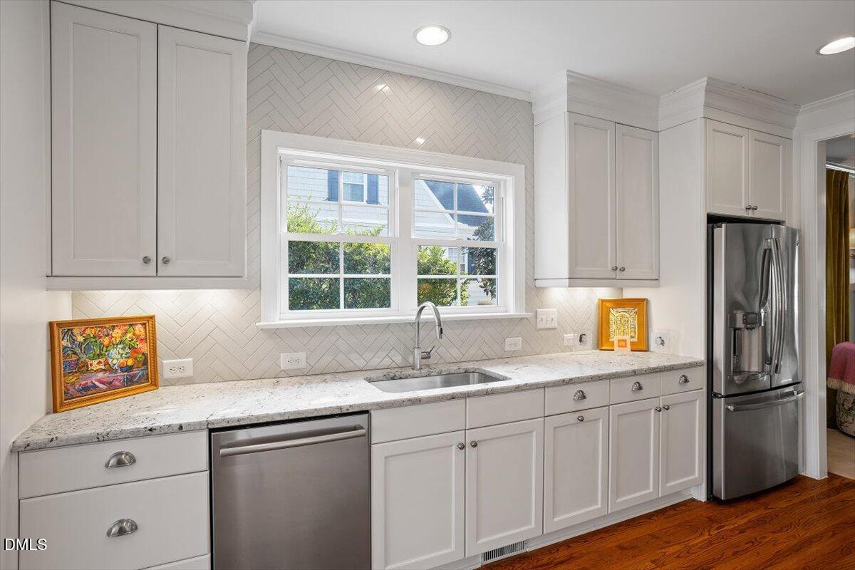 2104 Reaves Drive Raleigh, NC 27608 - Photo 12 of 29 a kitchen with appliances cabinets and a sink