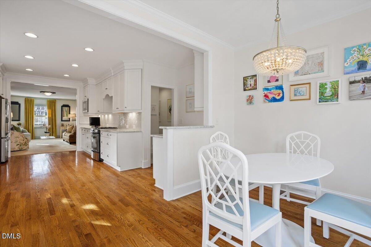 2104 Reaves Drive Raleigh, NC 27608 - Photo 15 of 29 a view of a dining room with furniture and wooden floor