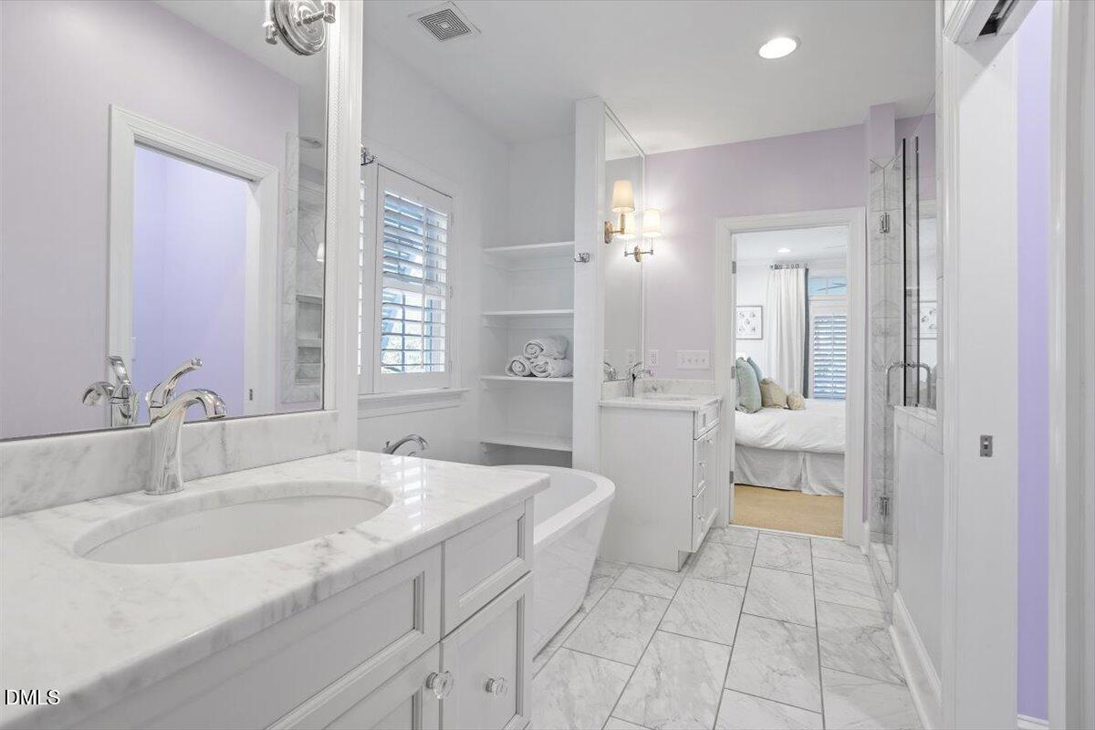 2104 Reaves Drive Raleigh, NC 27608 - Photo 20 of 29 a bathroom with a sink a toilet and a mirror
