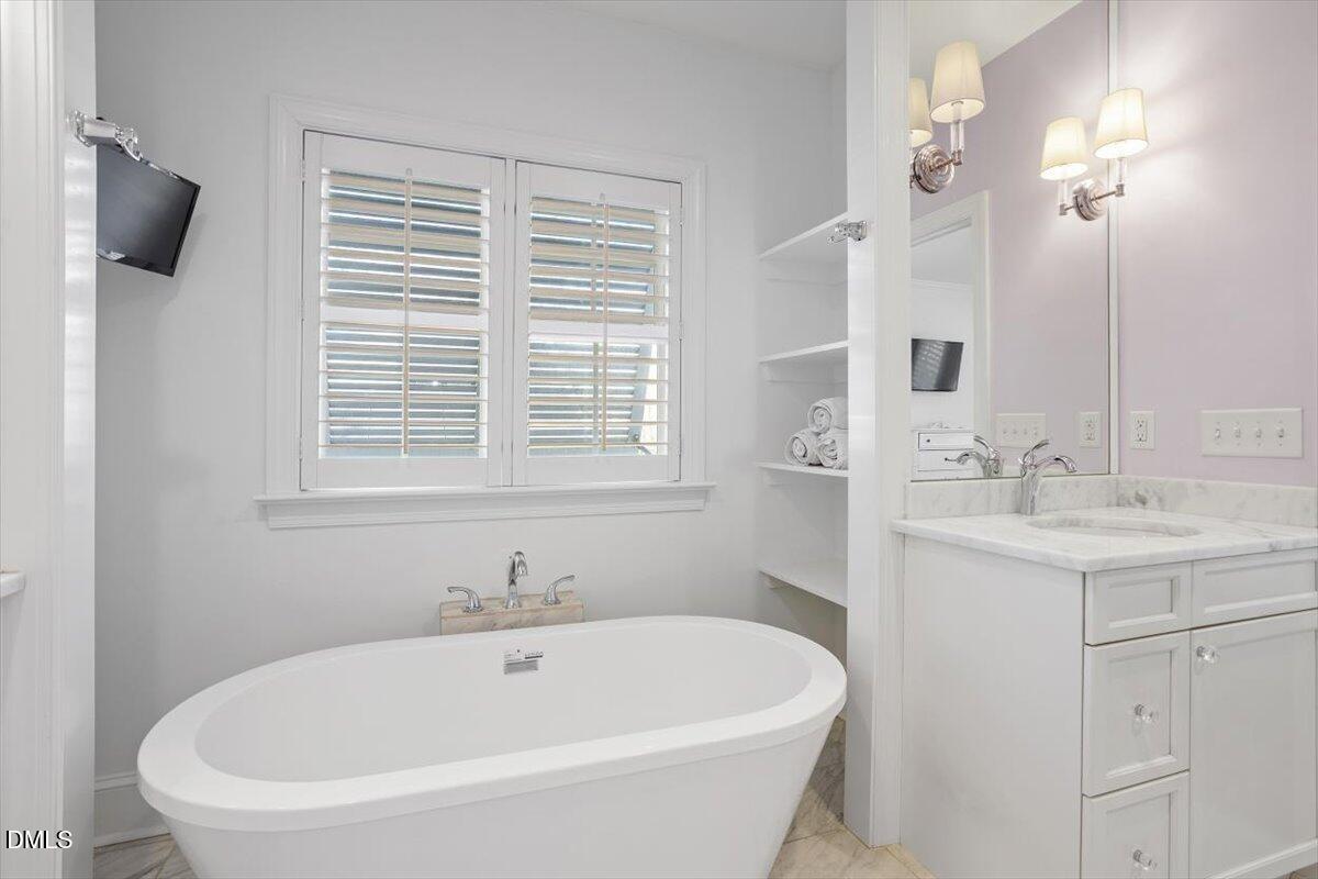 2104 Reaves Drive Raleigh, NC 27608 - Photo 21 of 29 a white bath tub sitting next to a white sink