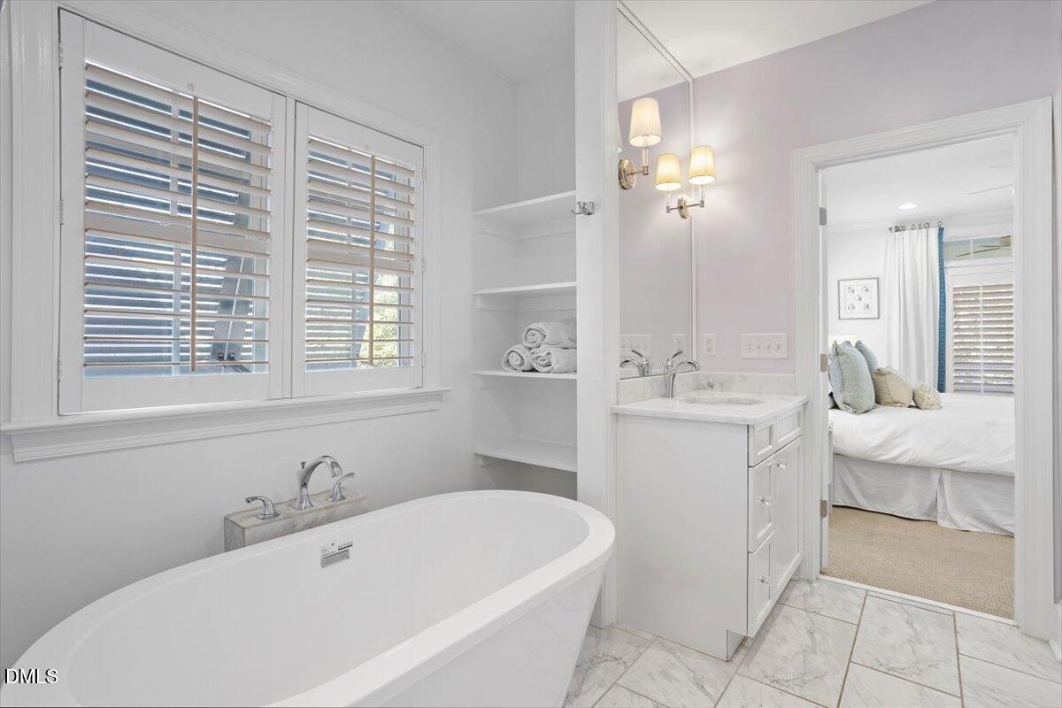 2104 Reaves Drive Raleigh, NC 27608 - Photo 22 of 29 a bathroom with a tub sink and mirror