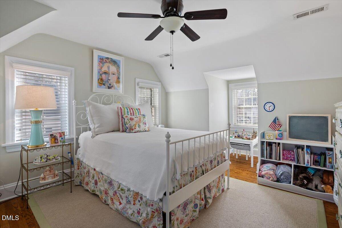 2104 Reaves Drive Raleigh, NC 27608 - Photo 24 of 29 a bedroom with bed and a book shelf