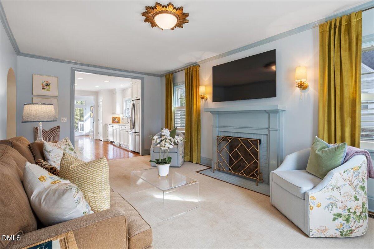 2104 Reaves Drive Raleigh, NC 27608 - Photo 4 of 29 a living room with furniture fireplace and flat screen tv