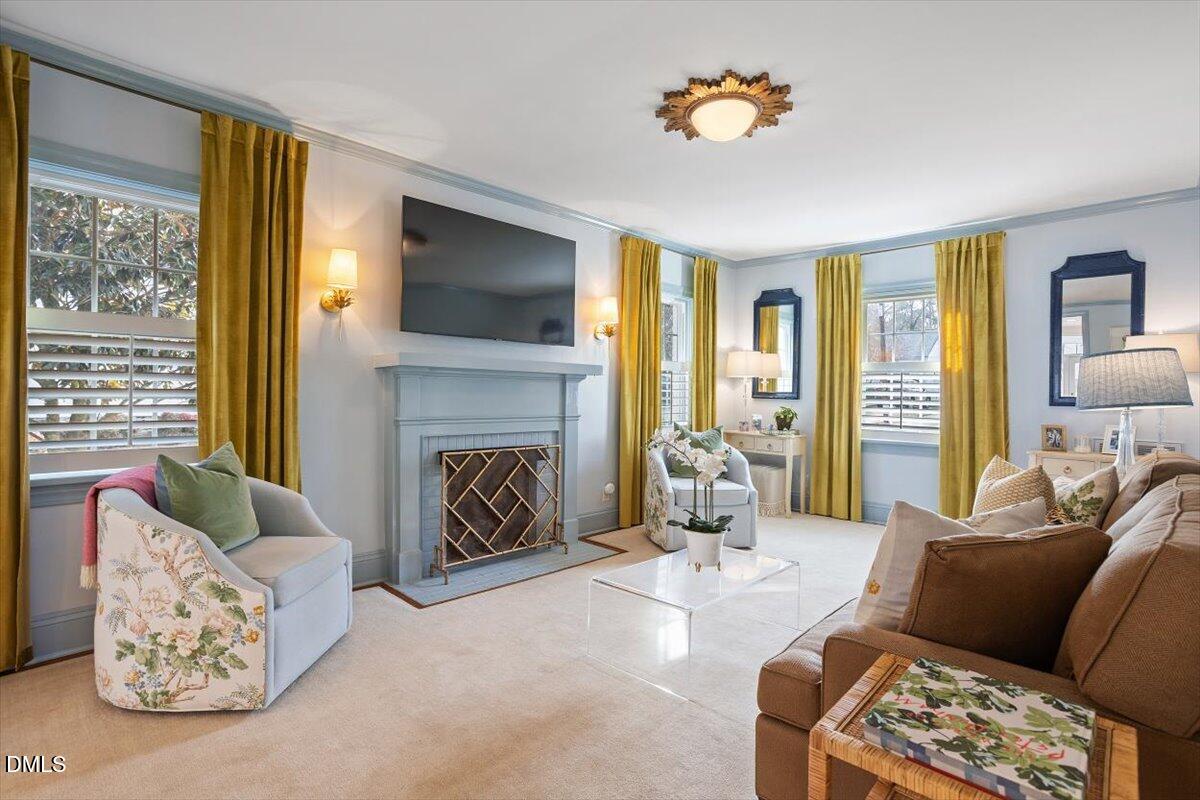 2104 Reaves Drive Raleigh, NC 27608 - Photo 6 of 29 a living room with furniture fireplace and a flat screen tv