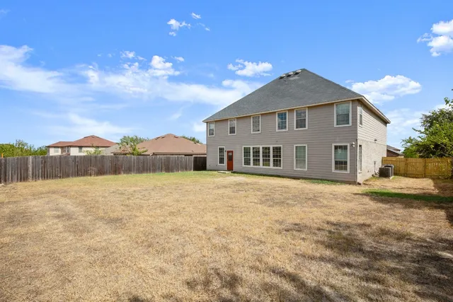 a view of a house with a backyard
