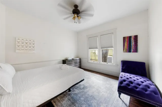 a bedroom with a bed couch and window