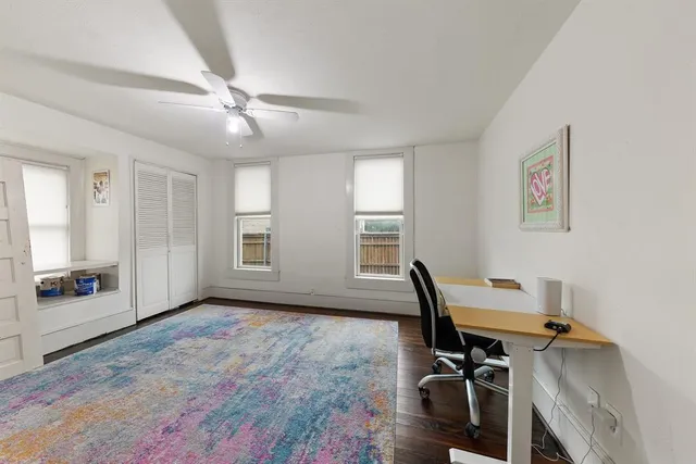a view of a workspace with furniture and a window