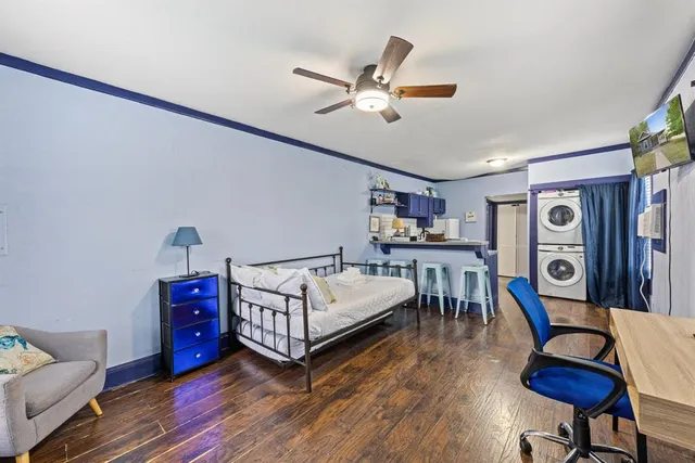 a living room with furniture and a wooden floor