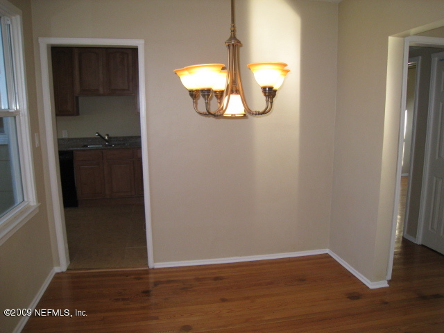 1759 Mayfair Road Jacksonville, FL 32207 - Photo 1 of 17 an empty room with wooden floor and windows